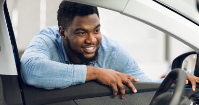 Man Looking At Car Interior In Dealership. New Car Checklist.