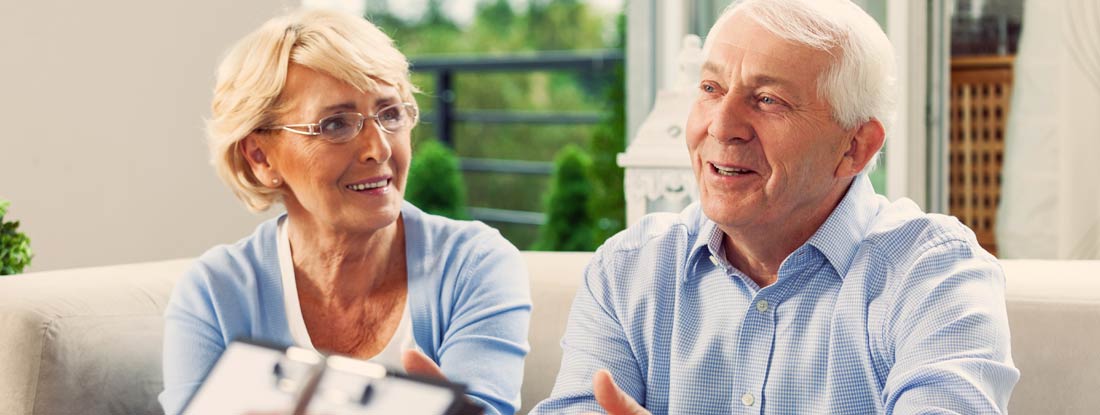 Senior couple having meeting with financial advisor or insurance agent at home. Annuity vs Life insurance.