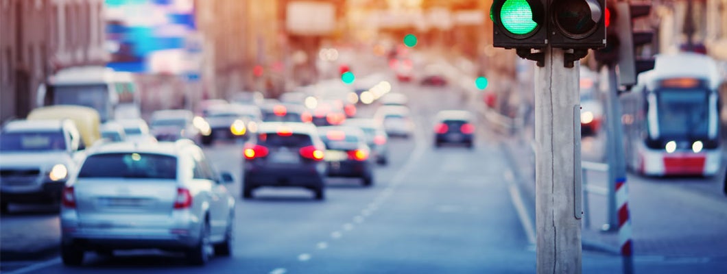 Cars moving on the road in Cincinnati in late evening. Find Cincinnati Ohio car insurance.