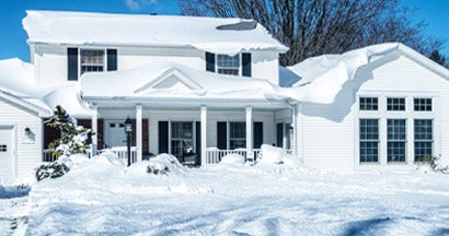 Deep Snow on Suburban Home Rooftop After Blizzard Snow Storm. Will Heavy Snow Damage my Roof? How Should I Fix It?