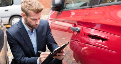 Insurance Agent Examining Car After Accident. What is Full Coverage Car Insurance?