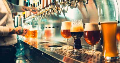 Glass of beer with barrel, bottle and fresh hops still-life. Finding the Right Insurance for Your Brewery.