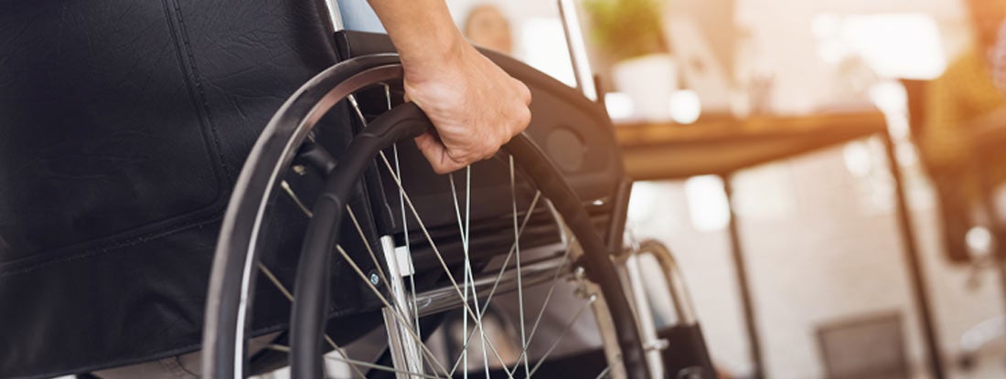 Person operating a manual wheelchair. Social insurance substitute.
