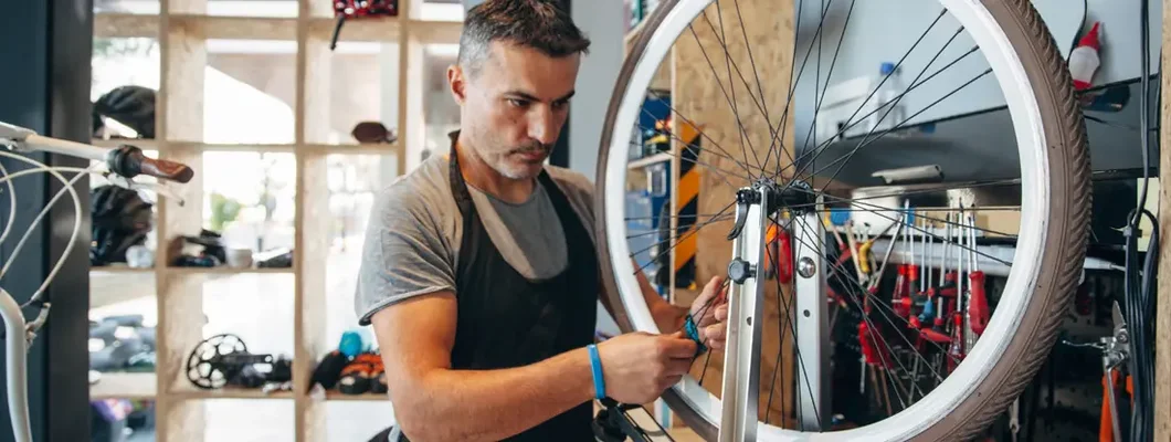 Bicycle service shop owner working on bike at bicycle. Find Parkland, Florida business insurance.