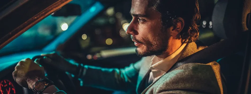 Man driving a car at night. Find Reno, Nevada car insurance.