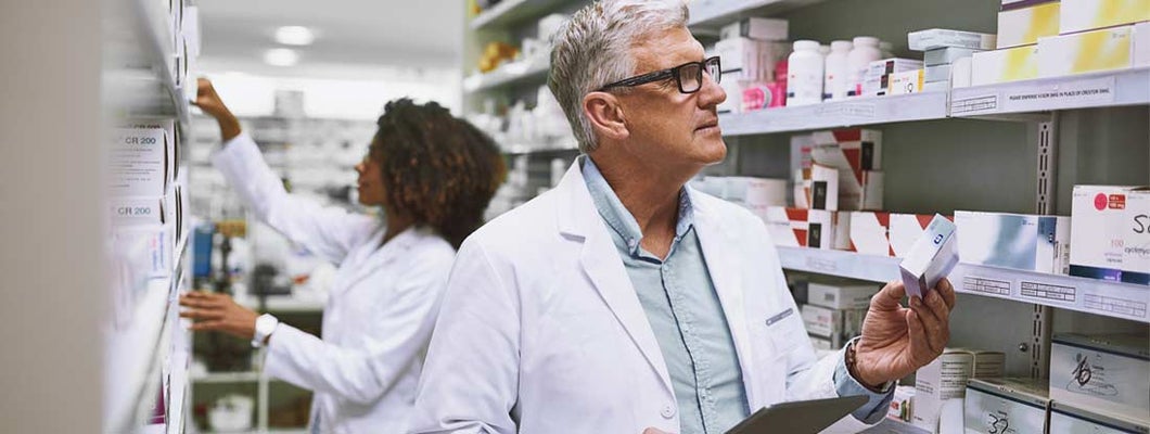 Two pharmacists taking stock inside of a pharmacy. Find medical malpractice insurance.