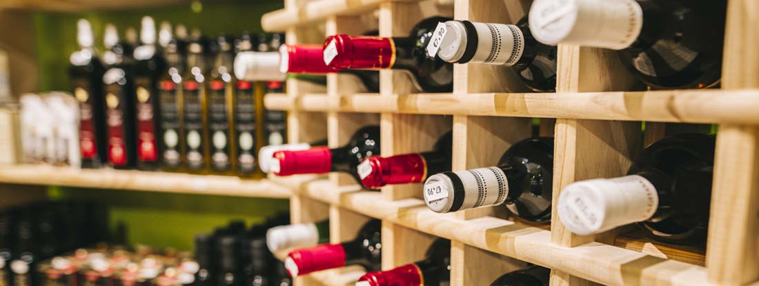 Wine bottles available for sale in a market. Find Liquor Store Insurance.