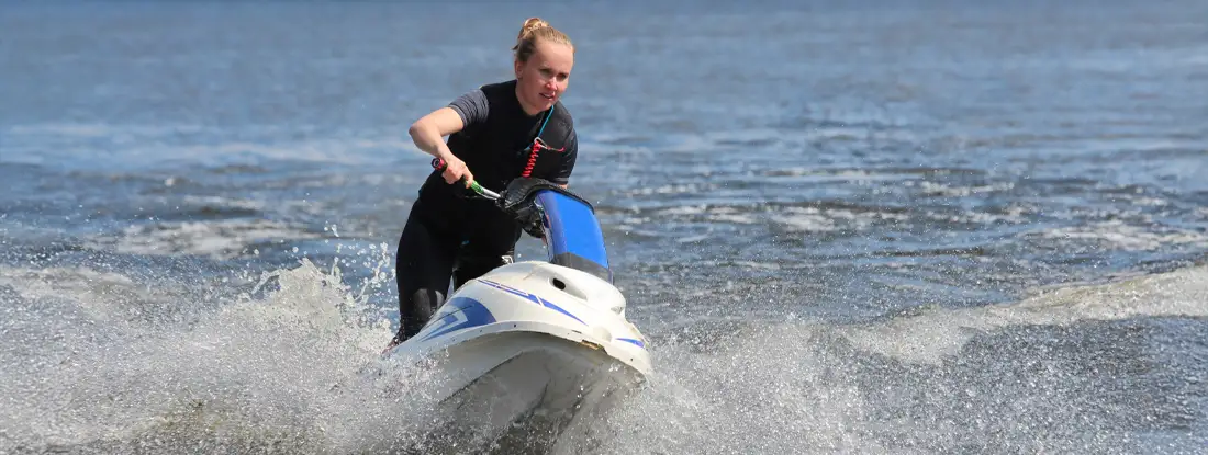 Young woman on stand-up jet ski. Find Stand-Up PWC Insurance.