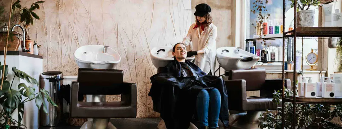 Hair washing and rinsing in fancy hair salon. Find Salon Insurance.