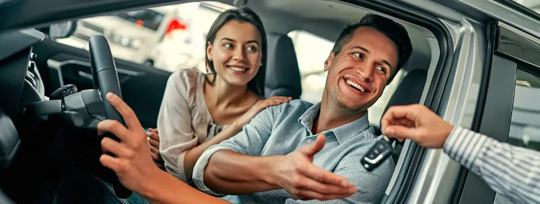 Couple bought a car in the dealership. Find New Canaan, Connecticut car insurance.