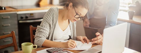 Photo of a young couple calculating how much they can spend on a home 