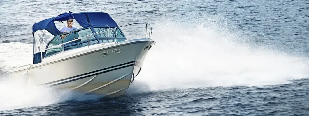 Man boating on lake. Find New York Boat Insurance.
