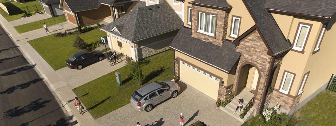 Aerial photograph shows a suburban residential neighborhood. Find Umbrella Insurance.