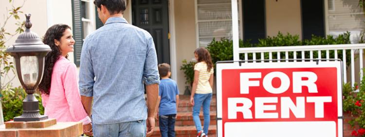 A family walks into their rented home.