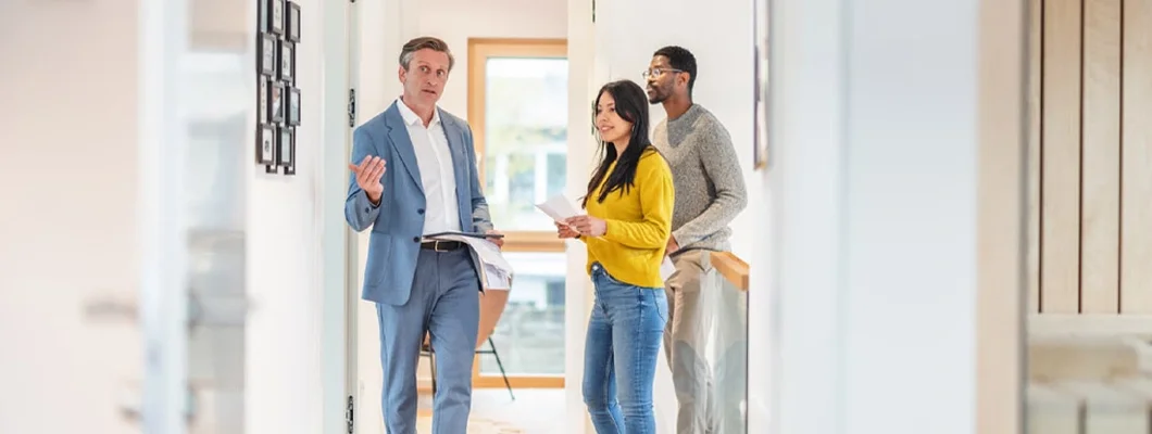 Landlord Showing Apartment To Couple Standing In Apartment. Find Nebraska Landlord Insurance.