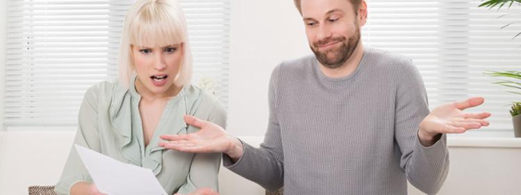 couple looking at car insurance bill