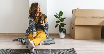 Smiling millennial women enjoying her new apartment
