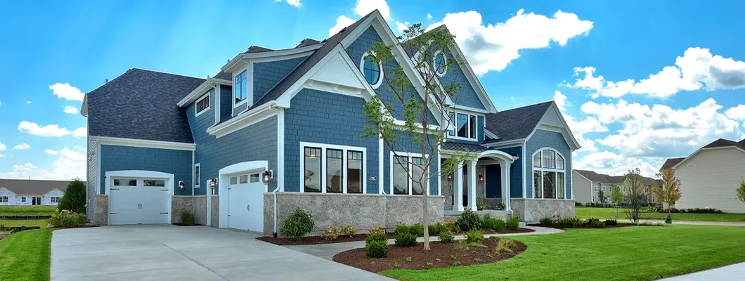 Large craftsman home with blue siding and three car garage. How to Find the Best Homeowners Insurance in Middleton, WI.