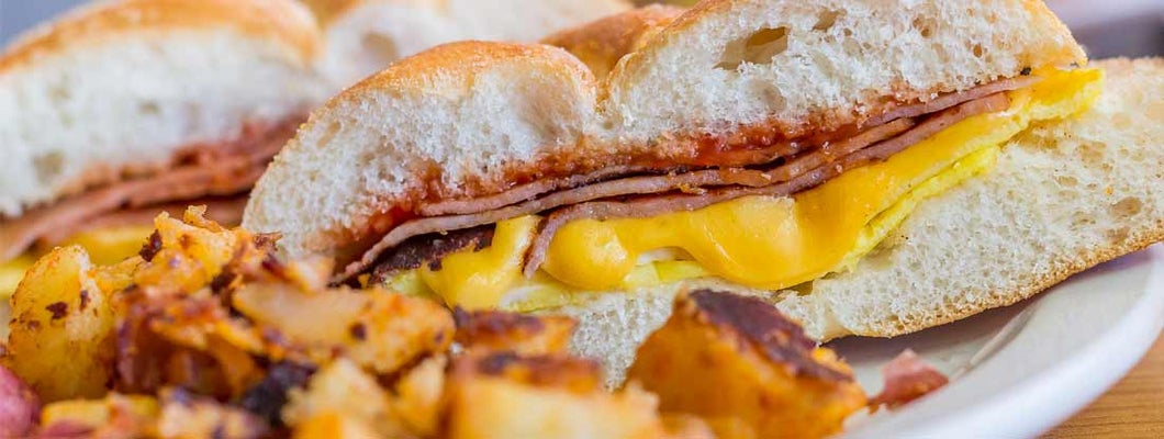 Taylor ham, pork roll, egg and cheese breakfast sandwich with home fries from New Jersey