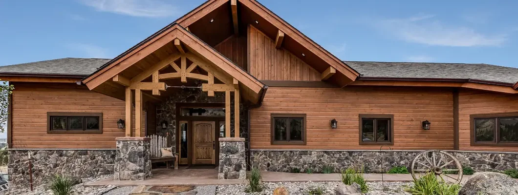All wood facade with many rocks and stones surrounding the home. Williston, North Dakota Homeowners Insurance. 