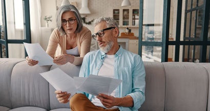 Couple taking care of their finances at home. Find Variable Life Insurance.