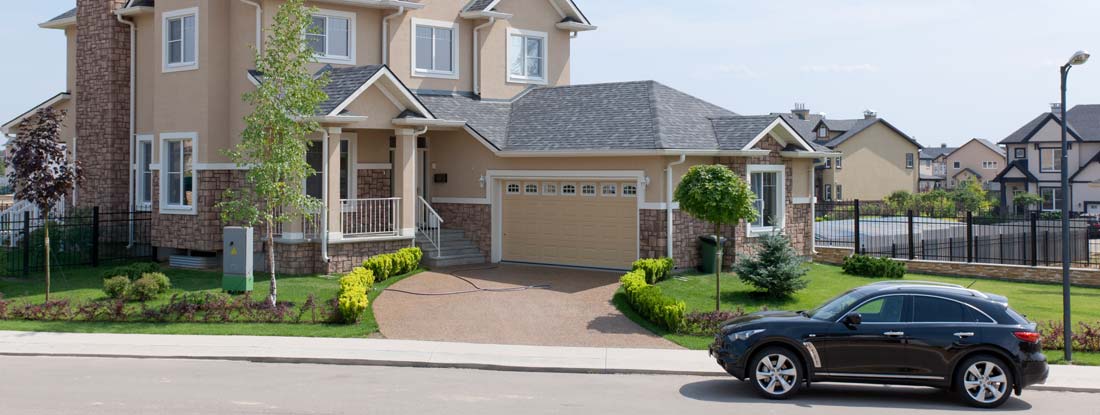 Suburban house in sunny summer afternoon. Find California umbrella insurance.