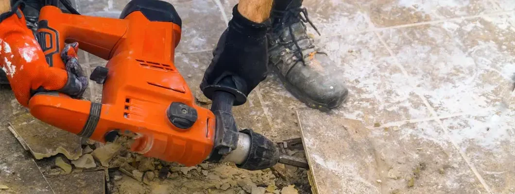 Preparation of repair the bathroom by removing old tiles with jackhammer. Find Demolition Contractor Insurance. 