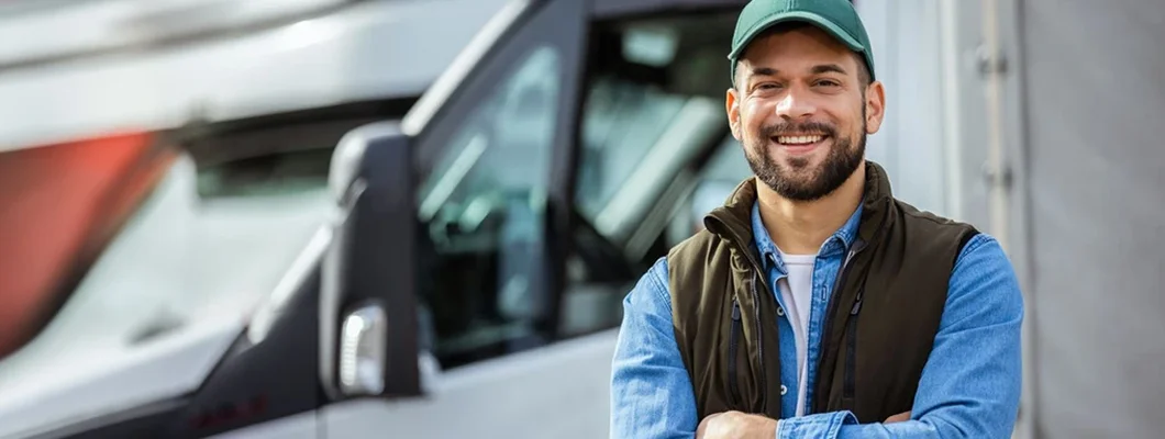 Male driver standing in front on his truck. New Hampshire Commercial Vehicle Insurance. 