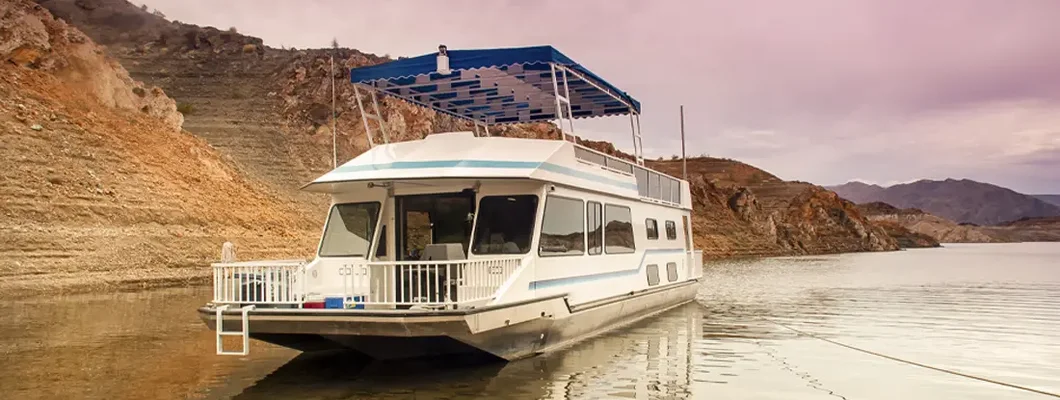 Houseboat on Lake Mead Nevada with cloudy sky. Find Nevada Boat Insurance.