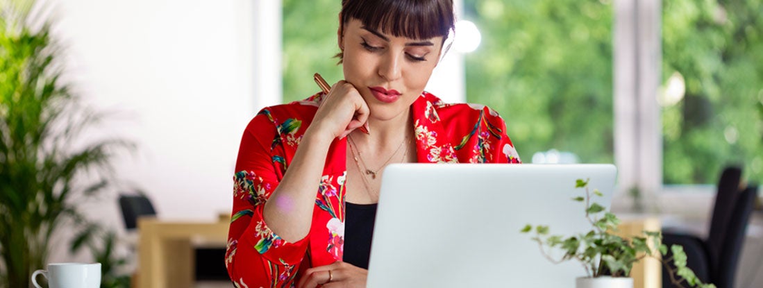 Woman reviewing paperwork. Missouri Errors and Omissions Insurance