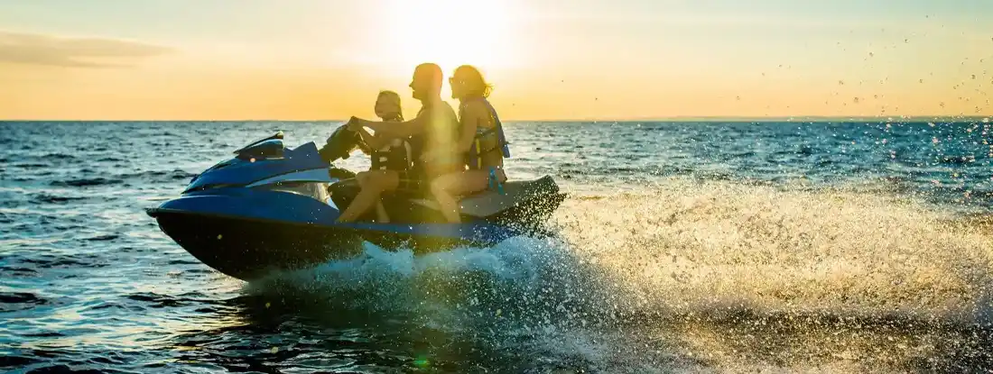 Riding A Jet Boat At Sunset. Find PWC Insurance Cost.