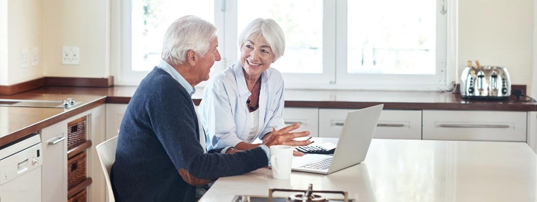 Senior couple working out their finances on a laptop at home. Variable annuities separate account.