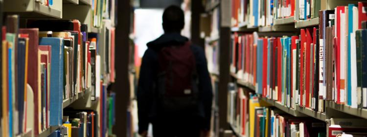 student in library