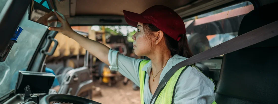 Female Truck Driver preparing to leave on road trip. Find Missouri Commercial Vehicle Insurance.