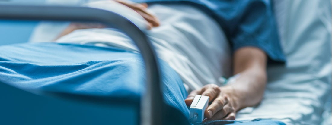 In the Hospital Sick Male Patient Sleeps on the Bed. Find Individual Long Term Disability Insurance.