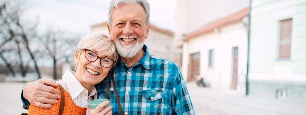 Senior couple walking together outdoors. Variable Annuity Examples.