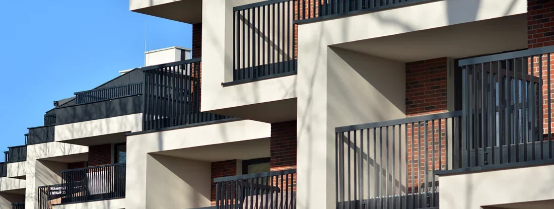 Modern apartment building on a sunny day with a blue sky. Find Mississippi Condo Insurance.