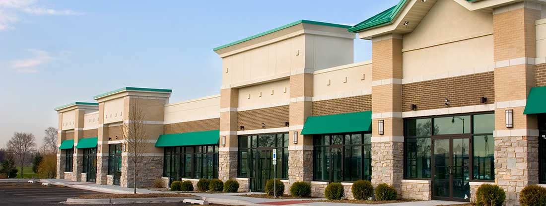 Multi-tenant retail space with stone and brick facade elements. Find Florida Commercial Property Insurance.