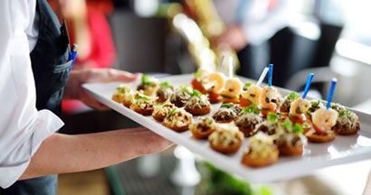 Caterer carrying plate for festive event. How to start a catering business.