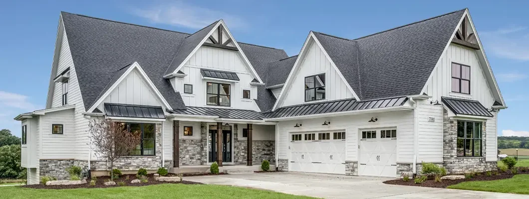 Large house with steep roof and side entry three car garage. How to Find the Best Homeowners Insurance in Biddeford, Maine.