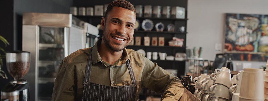 Barista standing at the counter of the coffee shop. Find Corinth, Mississippi business insurance.