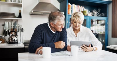 Mature couple using digital tablet to search for a pure life annuity specialist. Pure Life Annuity.