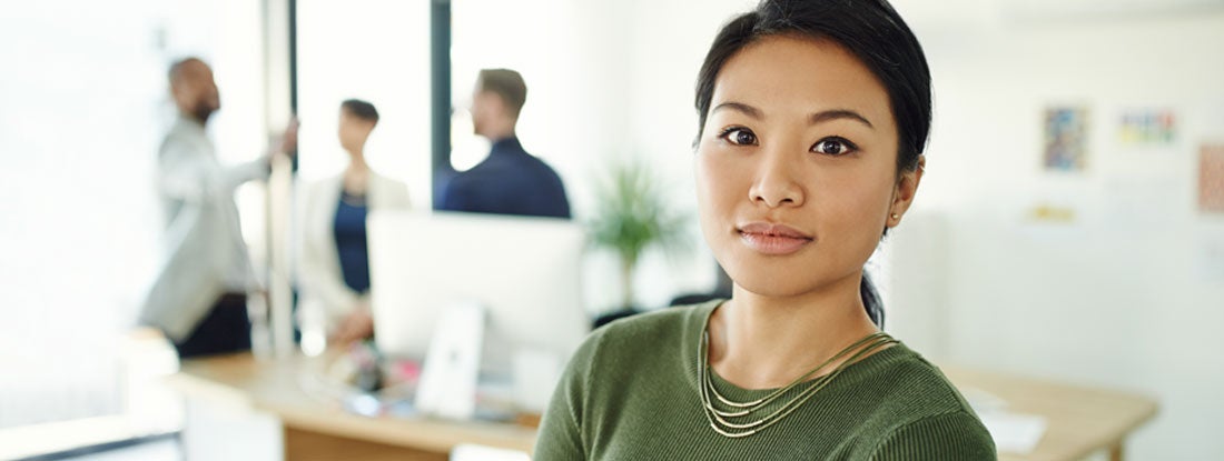 Woman in an office setting. Find Group Disability Insurance Cost.