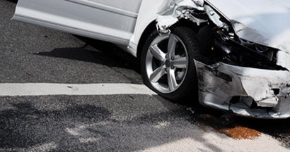 A white car just involved in a car crash at an intersection of a city street. What happens if you don't file a claim after a car accident?