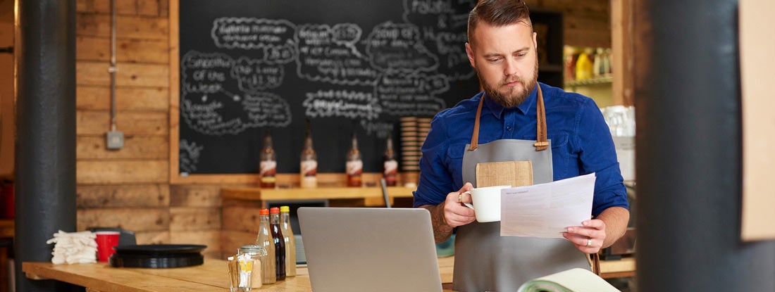 Restaurant owner reviewing insurance options. Find Business Insurance for Restaurants.