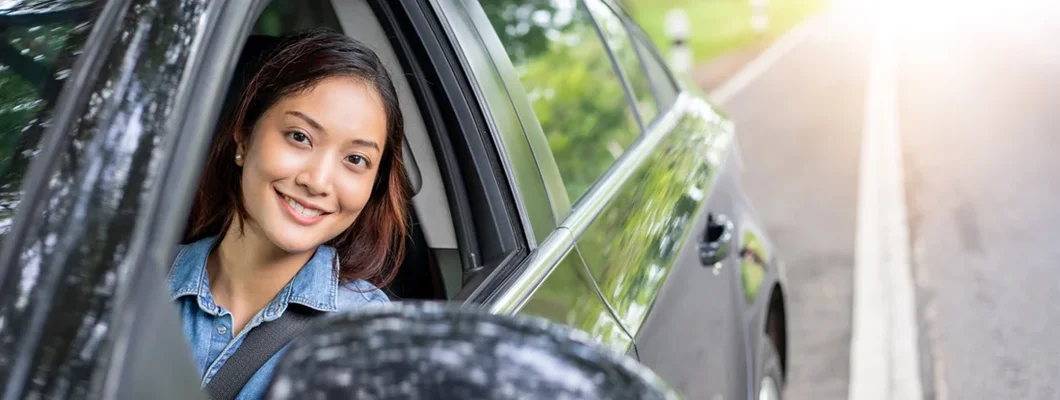 Woman driving a car on road for travel. How to Find the Best Car Insurance Policy in Simpsonville, South Carolina. 