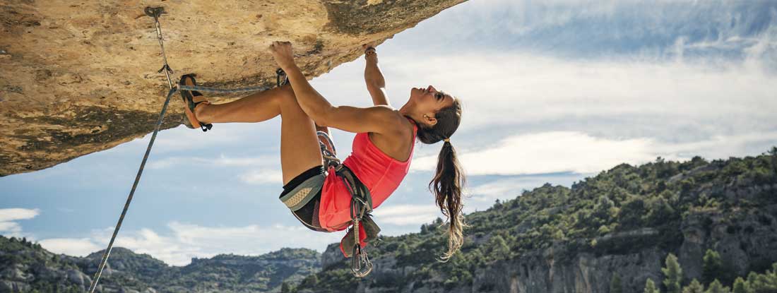 Female rock climber. Factors that affect life insurance premiums.