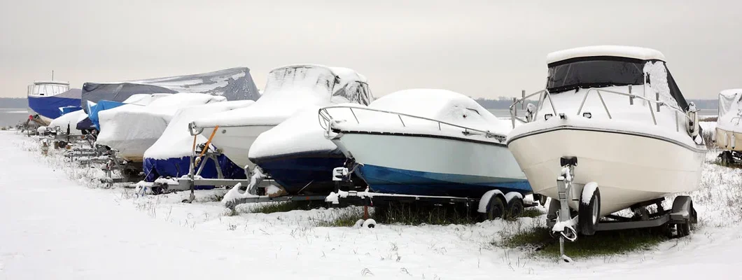 Boats on trailers in snow. Does Boat Insurance Cover Winter Storm Damage?