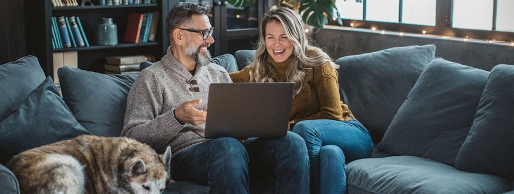 Mature couple at home using video call to talk with friends or family. Find Cleveland Ohio life insurance.