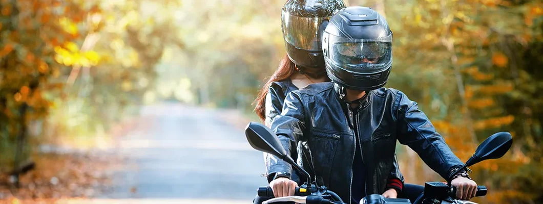 Couple biker riding motorcycle. Find West Virginia Motorcycle Insurance.